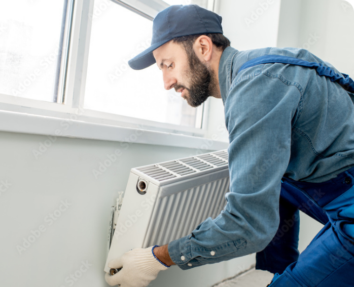 Professional HVAC installation at a residence under a window