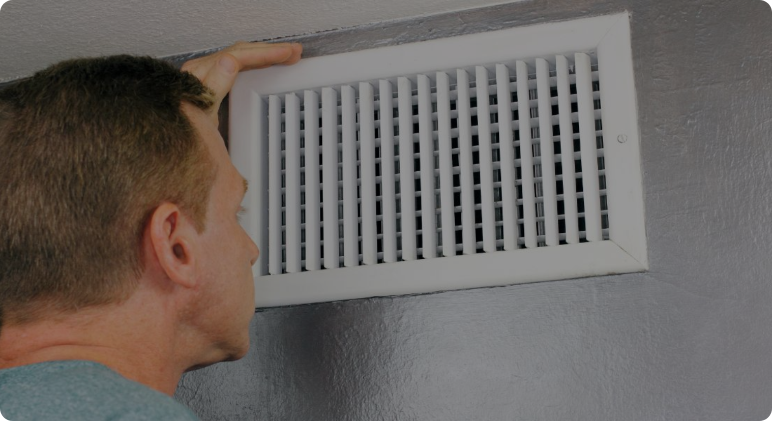 image of a man in his 50's looking at his HVAC vent for dust or dirt