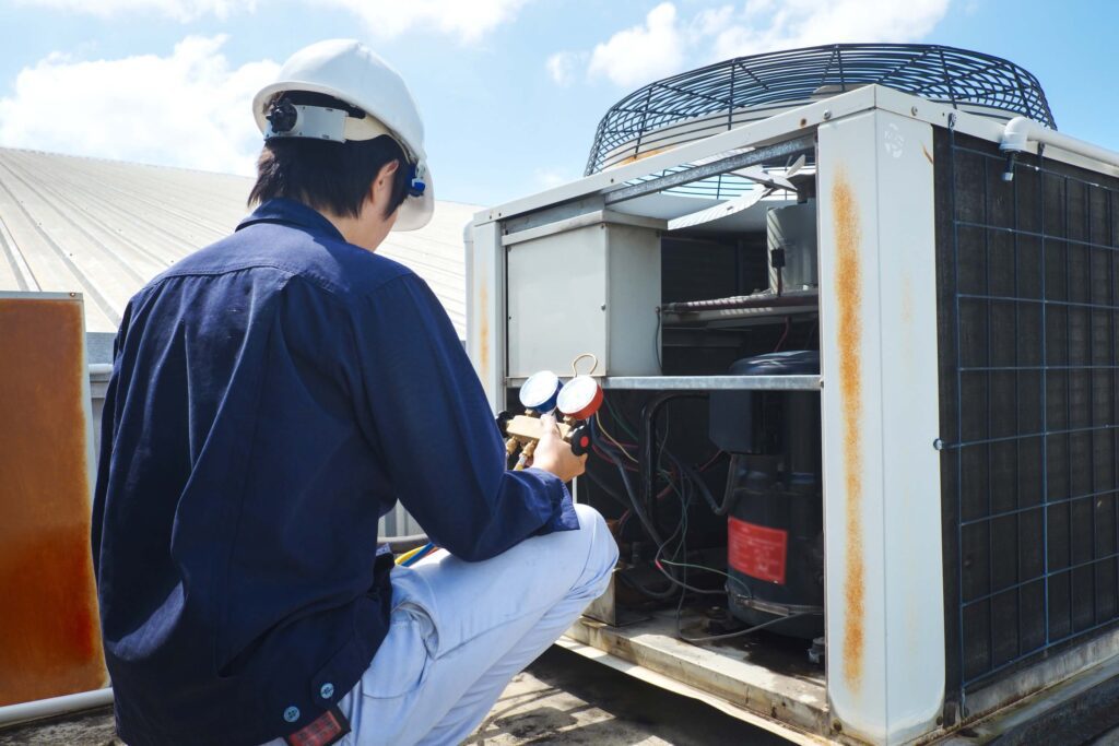 Technician is checking the air conditioner Technician is checking the air conditioner