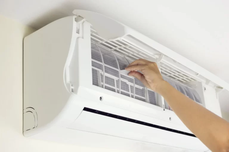 image of a person cleaning the filter of their split HVAC residential unit