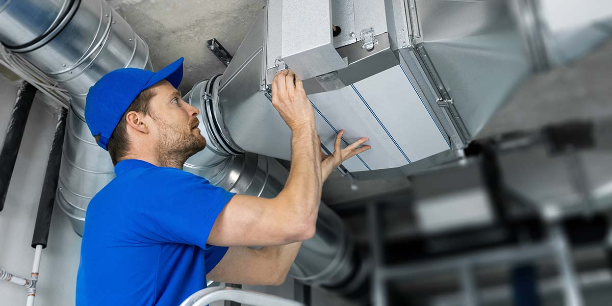 Join the Comfort Club: Why Regular HVAC Tune-Ups Are a Smart Investment - serviceman repairs HVAC